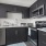 Spacious and well lit kitchen with wood flooring and stainless steel appliances