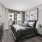 Large well lit bedroom with plush carpets and large windows 