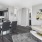 Spacious and well lit living room with wood flooring, large windows and open access to the kitchen